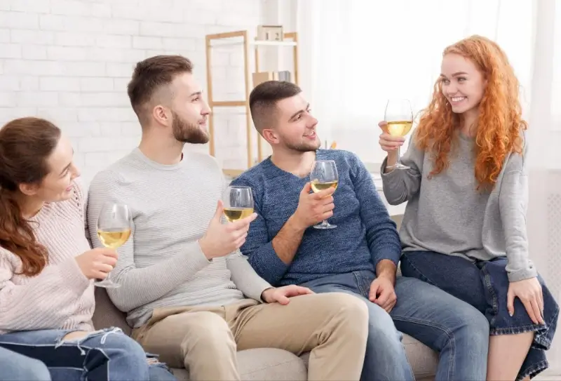 grupa znajomych pijąca wino w domu